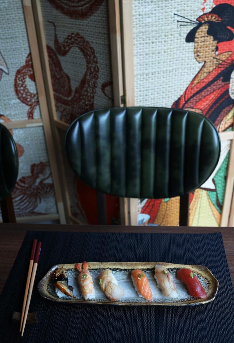Elegant sushi set elegantly displayed with a Japanese backdrop. Perfect for food and culinary themes.