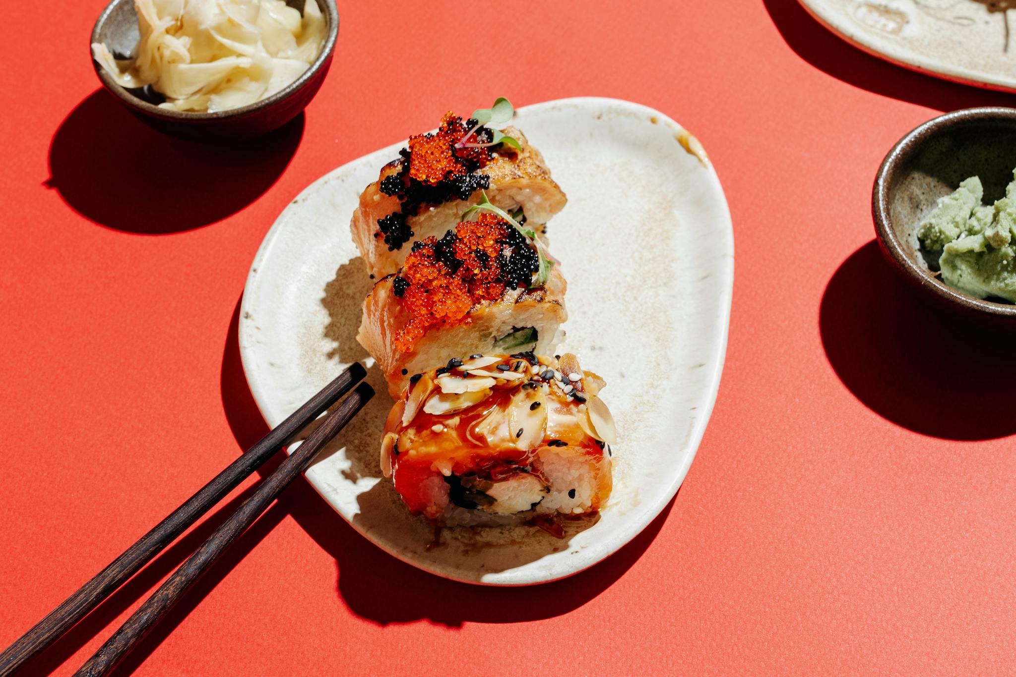 Vibrant sushi rolls on a plate with wasabi and chopsticks, perfect for Asian cuisine concepts.